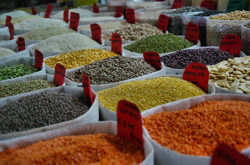 pexels-photo-1393382-1393382 Bags of vibrant grains and spices on display in a bustling market setting.